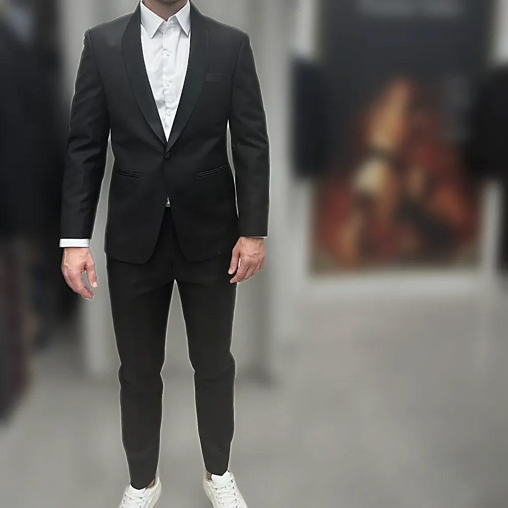 A black shawl-collar dinner suit worn with a white shirt, in the shop