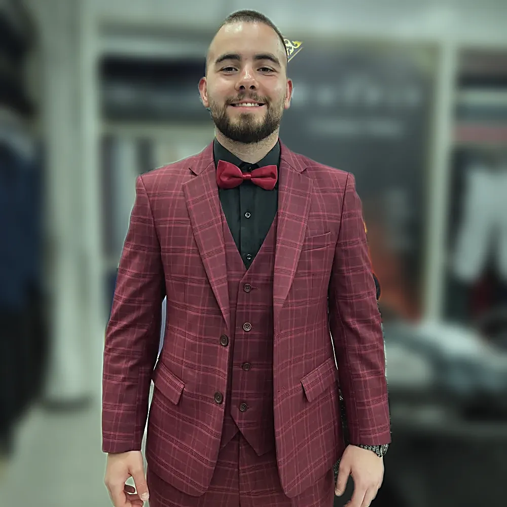 A burgundy checked three-piece suit with a matching bow tie, worn in the shop