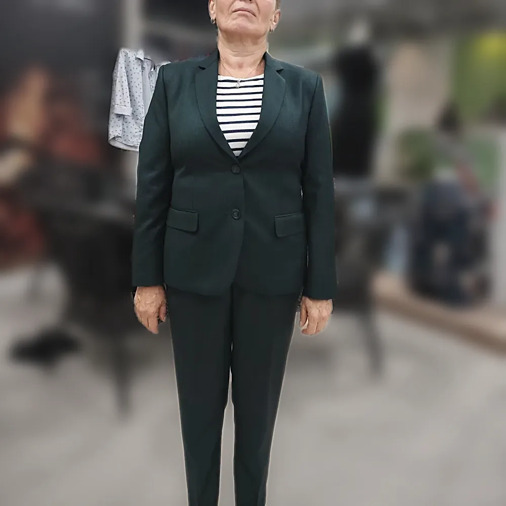 A dark green women's trouser suit, jacket and trousers, worn in the shop