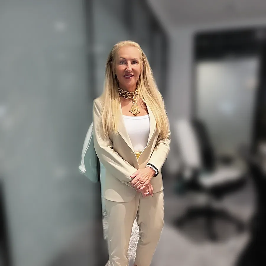 A client in a cream trouser suit standing in an office — from Maxine Braddock's review