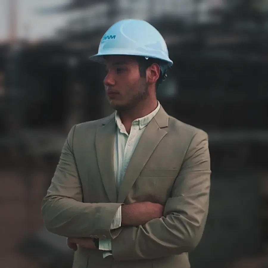 A client in a beige suit jacket and a hard hat, arms folded, on a building site — from steven Fejes's review