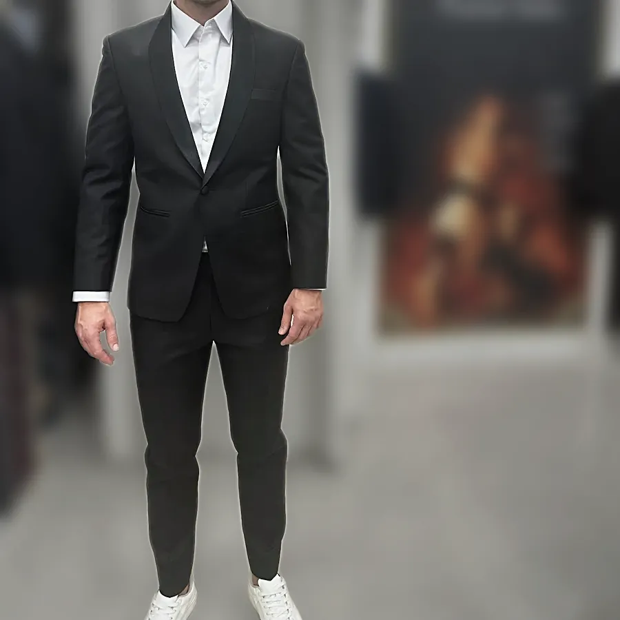 A client in a black suit and white shirt standing in the shop — from Tobias Friedl's review
