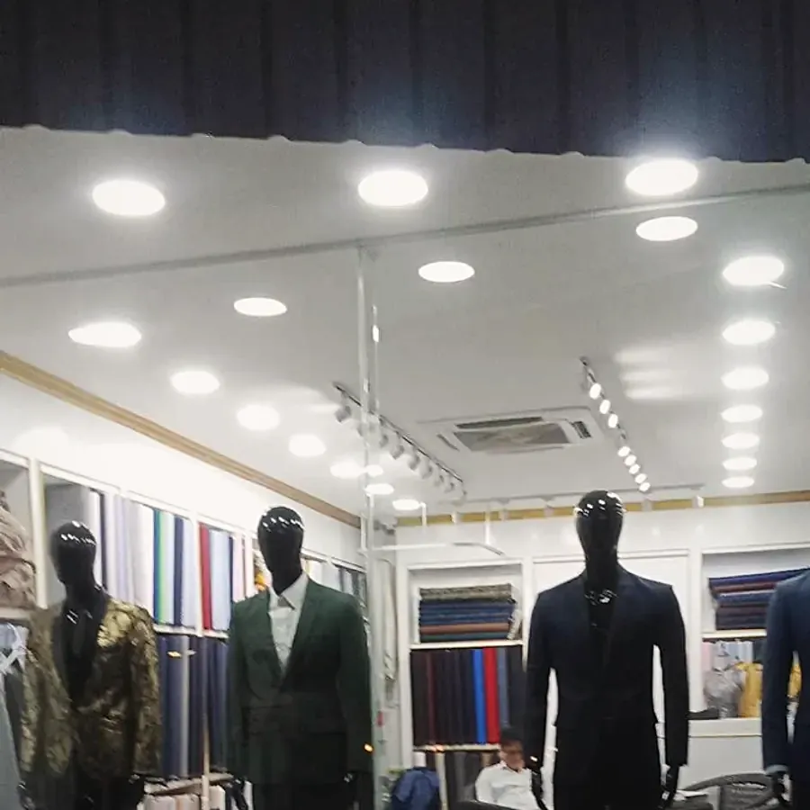 Suits on mannequins inside the shop under the ceiling lights — from vincent der's review
